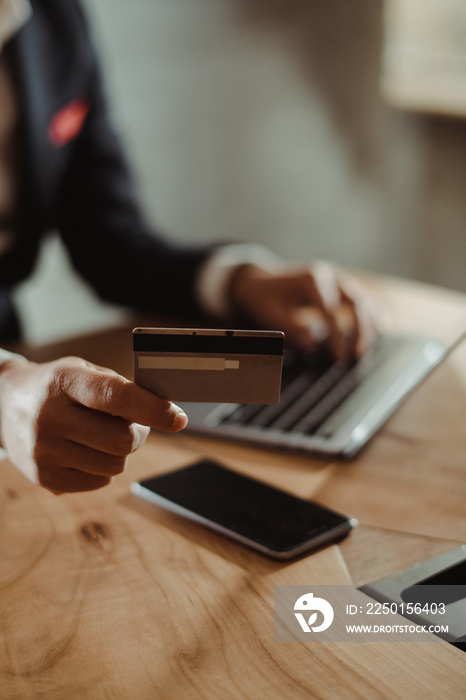 Man holding credit card and paying online