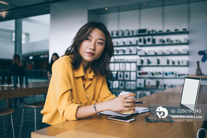 在电子商店办公桌旁体贴的女工