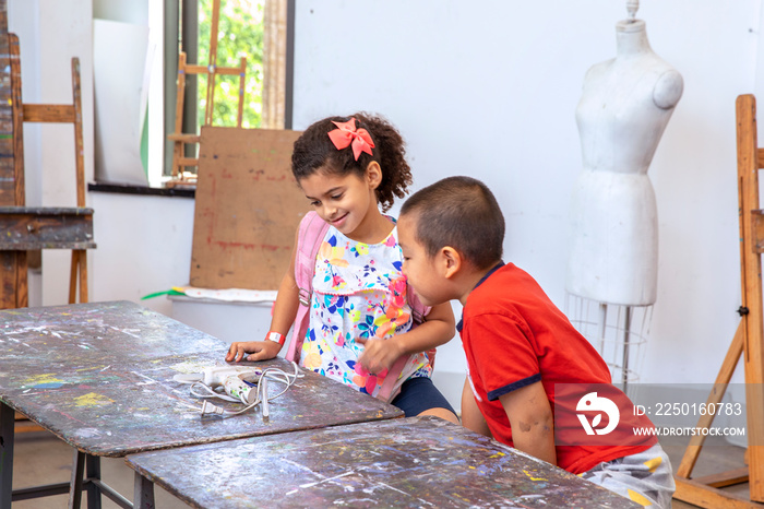 Young children looking at an appliance