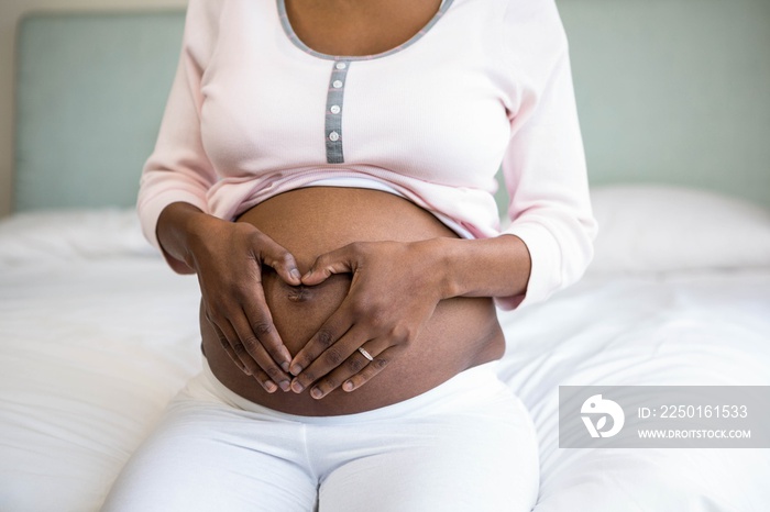 Pregnant woman doing heart shape