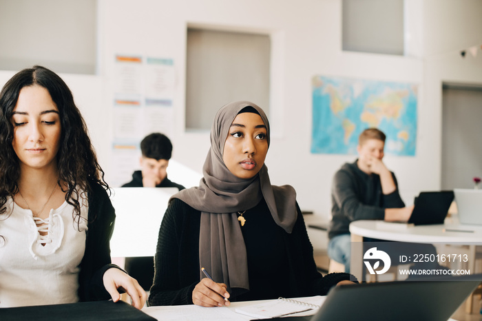 Students listening in class during lecture at university