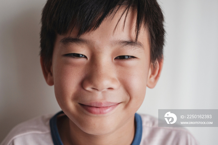 Portrait of happy Asian tween preteen boy smiling