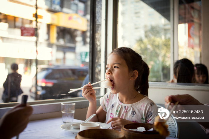 Girl having lunch in restaurant