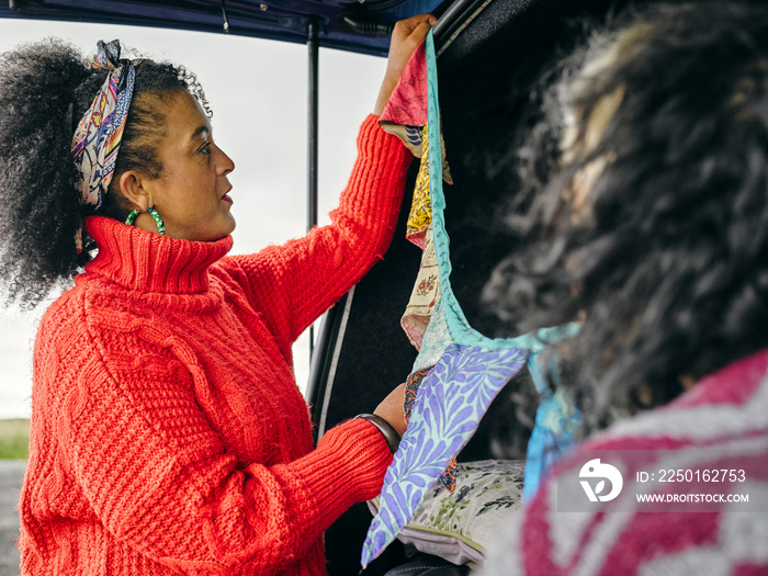 Women hanging decorations in van