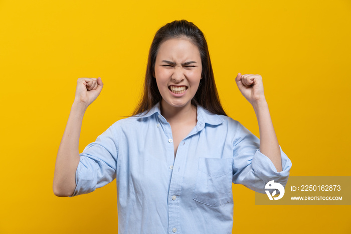 Excited winner woman scream after received good news isolated on yellow background in studio.