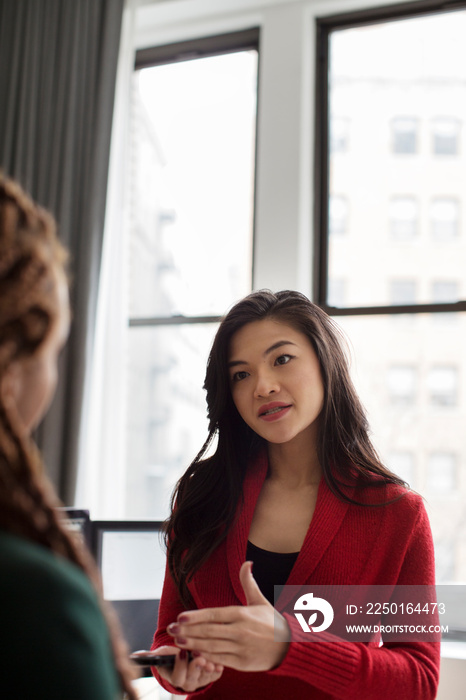 Two businesswomen discussing in office