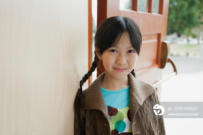 Pretty, Asian, elementary student at school doorway