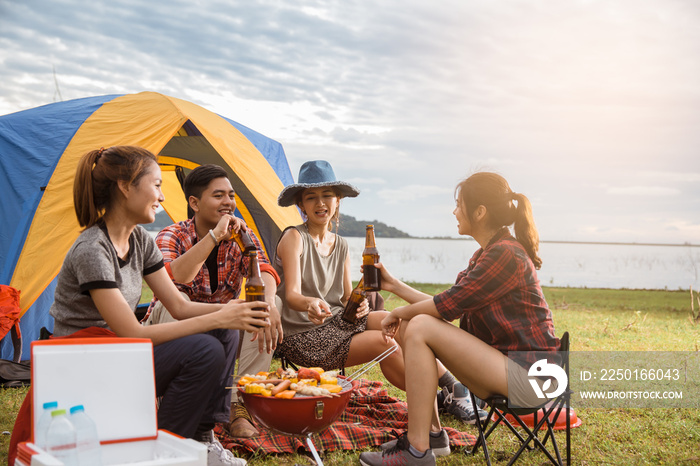 Group of Friends Drinking beer in Camping, people in asian are celebrating the festival they clink G