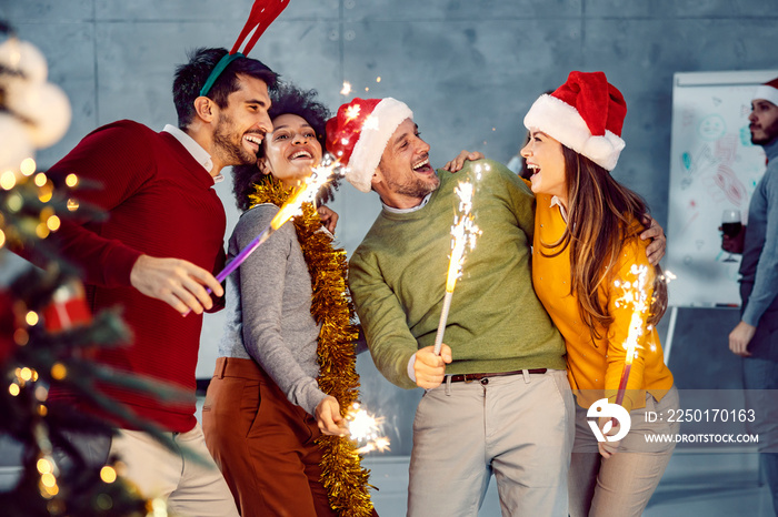 New Year and Christmas celebration. A small group of multicultural friends standing in the office an