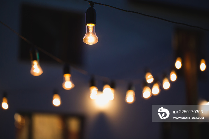 outdoor string lights hanging on a line in backyard