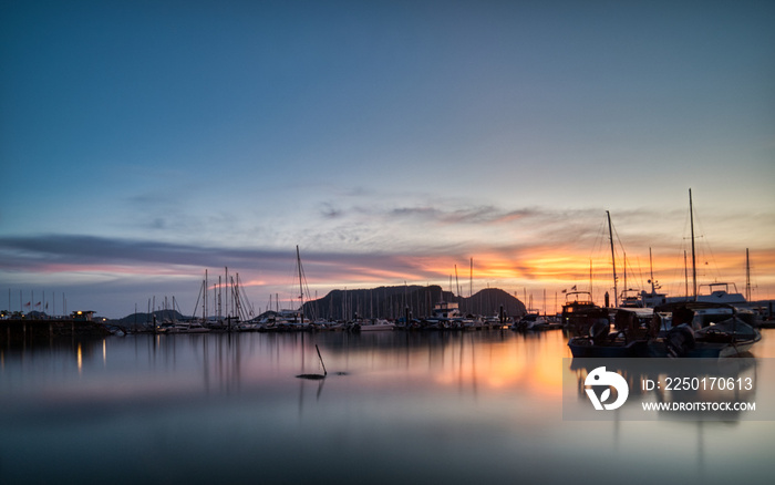 Boat docked in Harbour during sunset