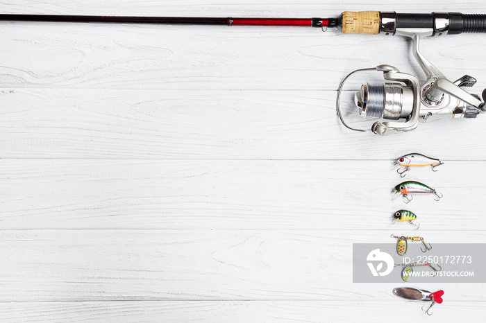 the fishing rod stand on the wooden background.