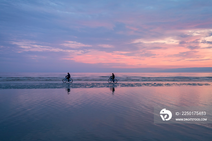 Bicycling in the Surf at Sunrise, St Simons Island, Georgia