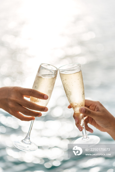 Hand holding a glass drinking wine on Sunset sea background.