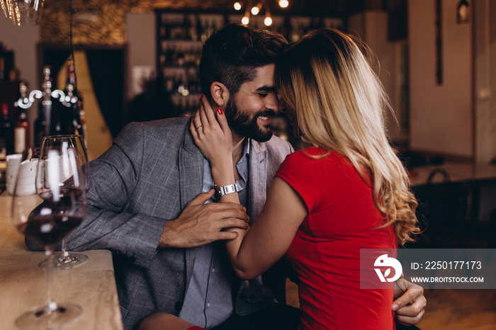 Romantic date in restaurant, young couple at bar counter.