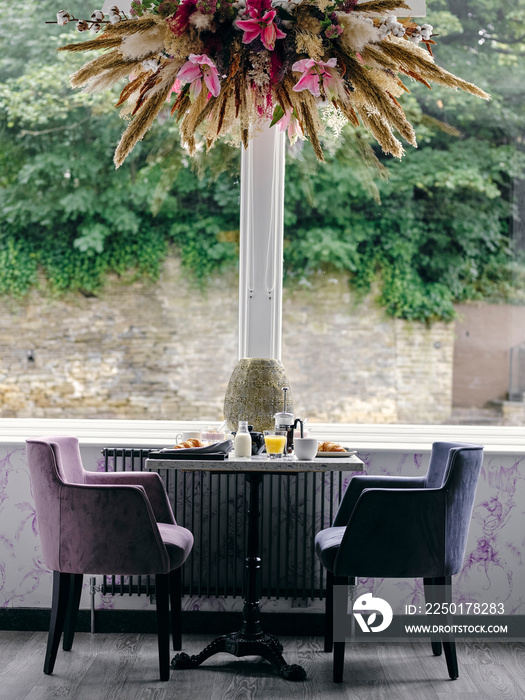 UK, Hotel breakfast table with two armchairs