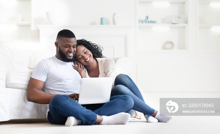 Cute african american couple searching hotel and resort online