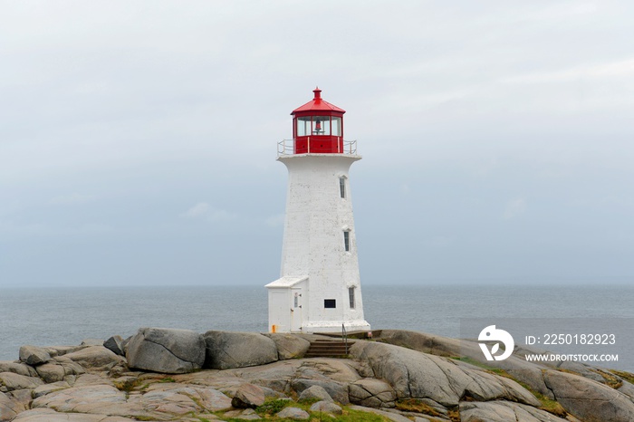 Peggys Point Lighthouse in cloudy in historic Peggy`s Cove, Nova Scotia, Canada. The lighthouse was 