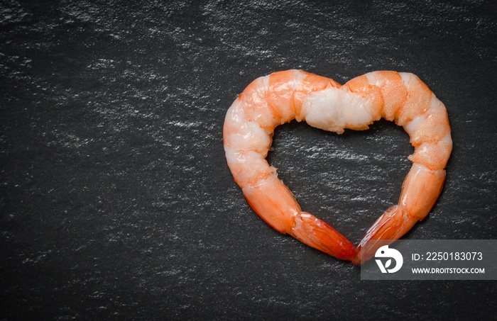 Seafood two shrimps heart shape / Cooked shrimp prawns on dark background