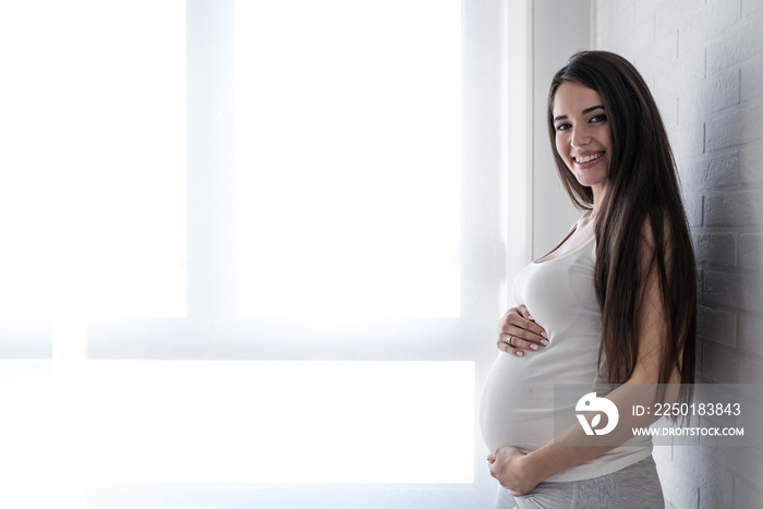 Beautiful young smiling pregnant woman. Happiness