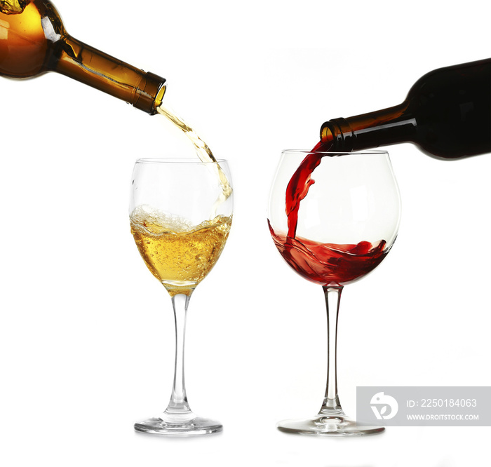 White and red wine pouring in glasses, isolated on white