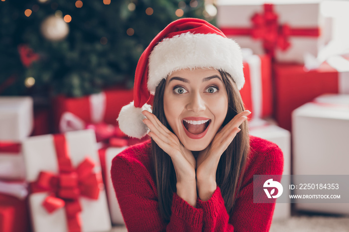 Photo of excited cute lady boxes arms face open mouth wear santa headwear red pullover in decorated 