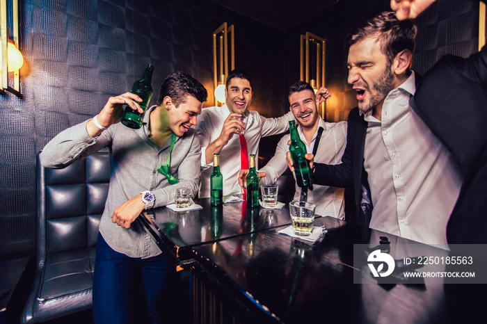 Group of young men toasting at a nightclub