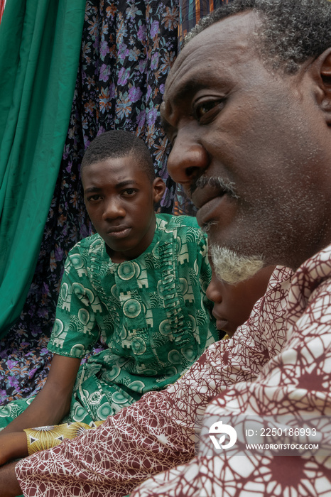 Portrait of African father and two sons sitting