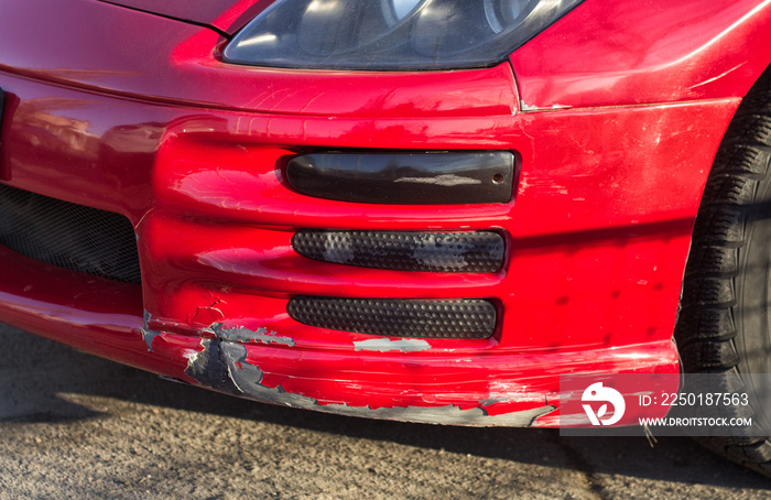 broken car bumper of  red sport car with lowered suspension