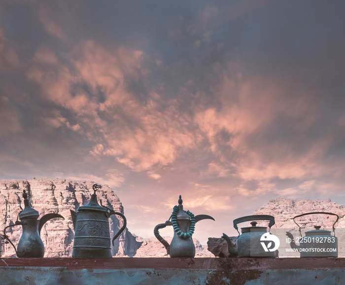 arabic vintage teapots on the background of sandy mountains and sky