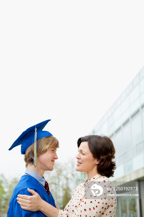 young male graduate with his mother