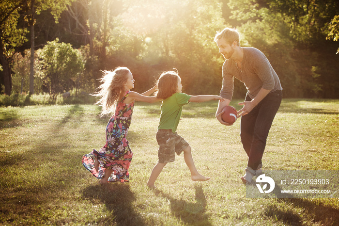 Father playing with his children in backyard