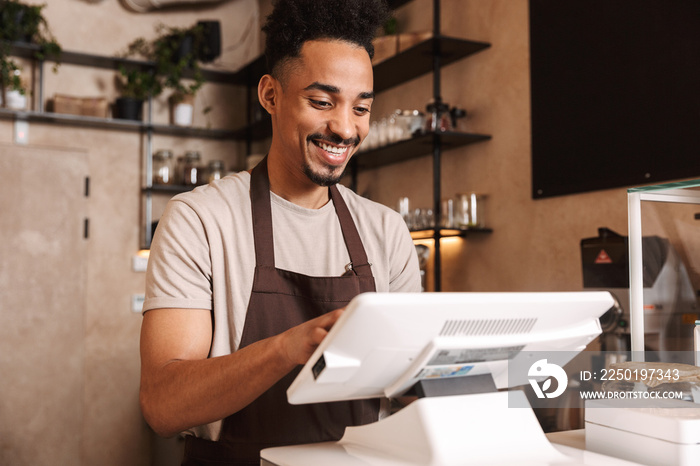 Smiling attractive man barista standing