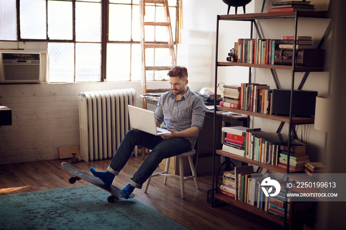 Young man using laptop in living room