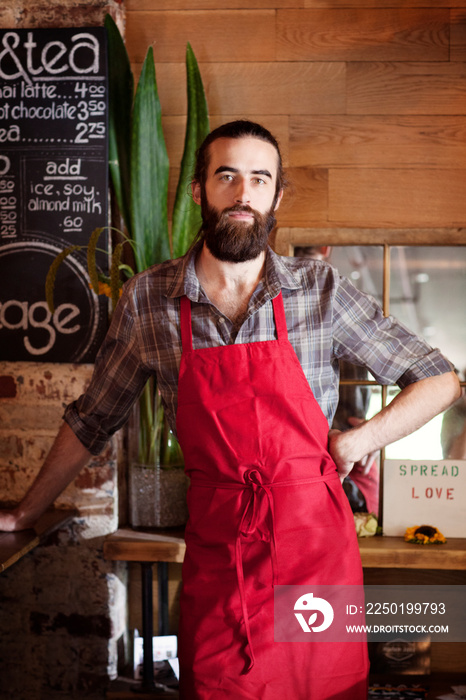 Portrait of small business owner wearing red apron