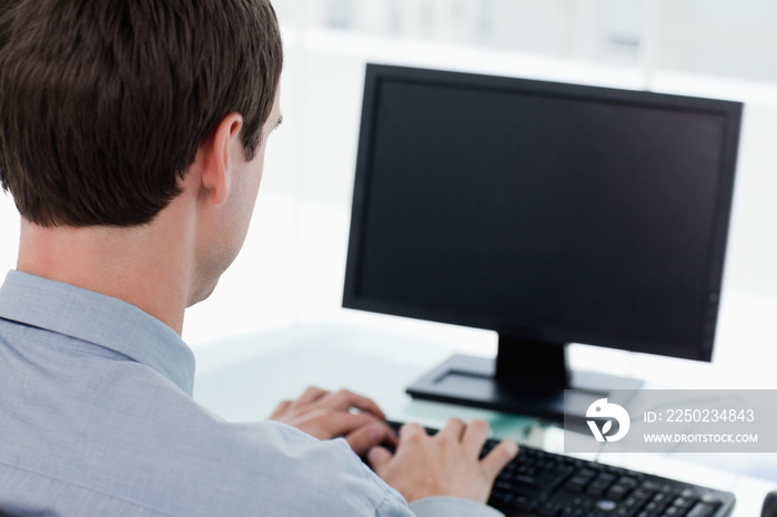 Back view of a businessman working with a computer