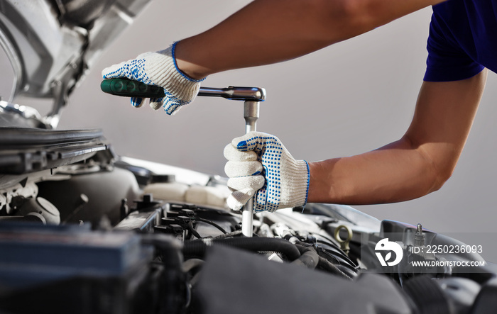 Mechanic working in auto repair garage. Car maintenance