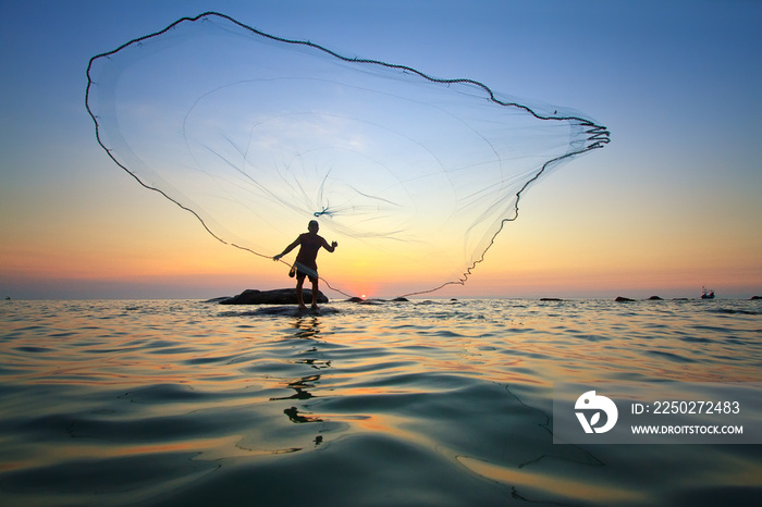 throwing fishing net during sunrise