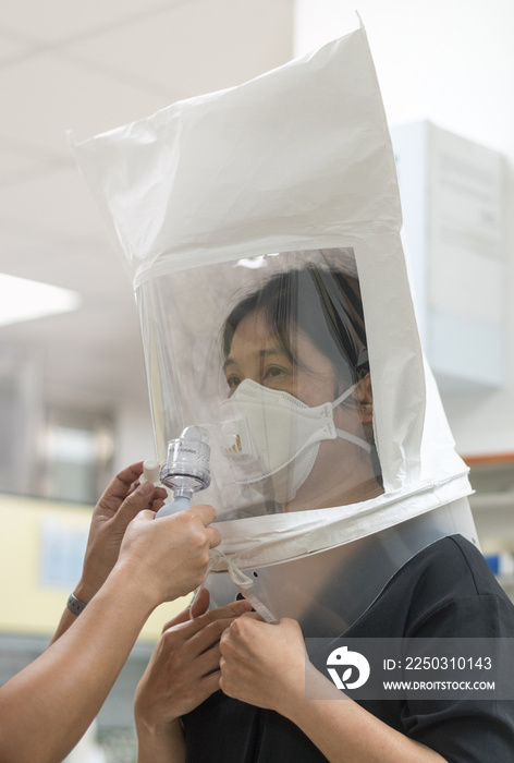 Respirator fit test prepared for COVID-19. Asia man testing repiratory system with N-95 surgical mas