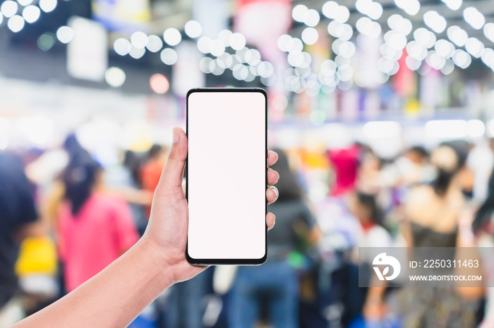 Mobile phone mockup image, hand holding blank screen mobile smart phone with blurred  Crowd of peopl