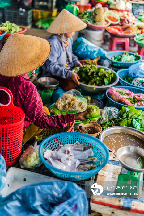 Women selling food on the street of Hoi An, Vietnam