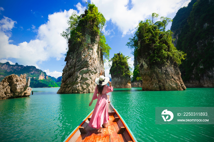 Asian woman posing on boat in Ratchaprapha dam Khao sok national park at suratthani,Thailand.