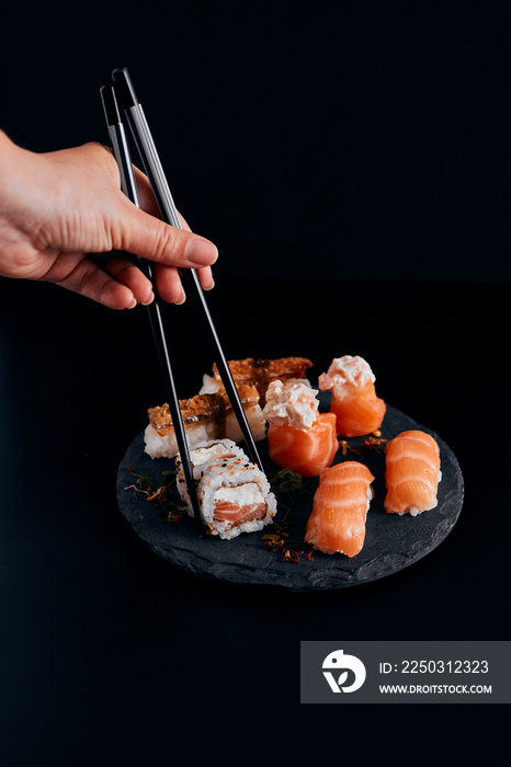 sushi on a plate black background