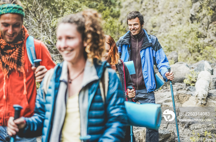 Young people doing trekking excursion in mountains path - Hikers walking in nature path outdoor - S