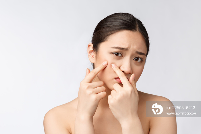 Face Skin Problem - young woman unhappy touch her skin isolated, concept for skin care, asian.