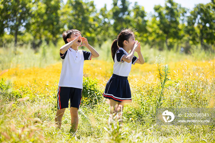 快乐的小学生朝着远方大喊