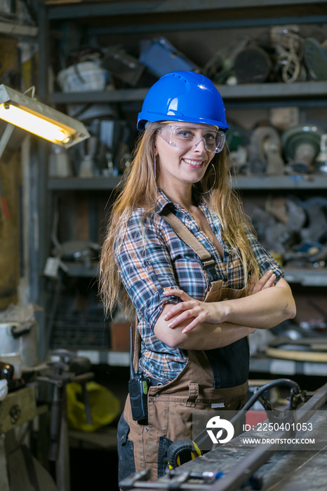 young woman worker posing in a workshop