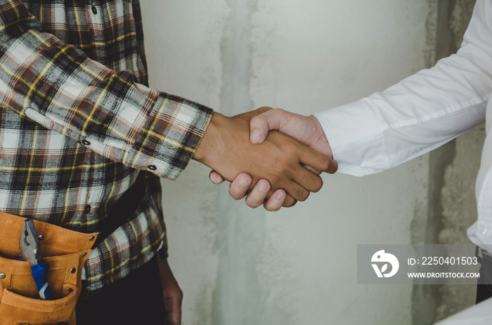 construction worker team contractor hand shake with engineer after finishing up business meeting to 