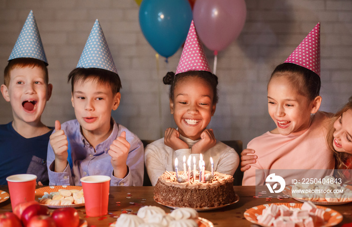 African-american girl celebrating birthday and making wish