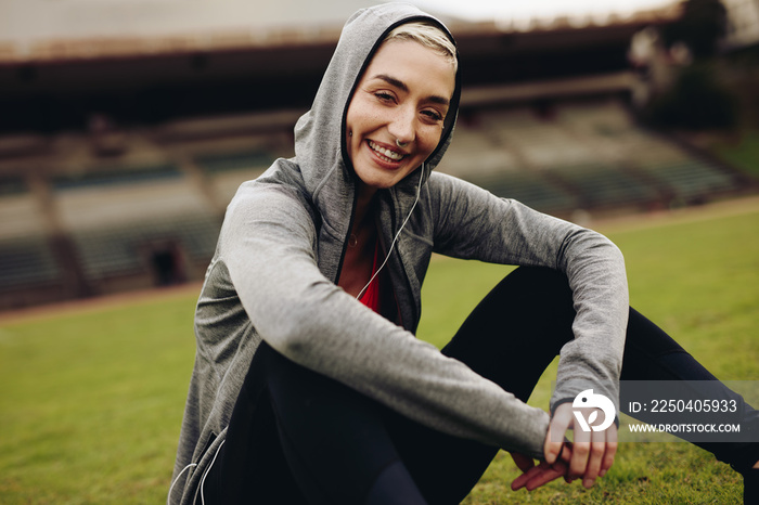 Female athlete relaxing on running track